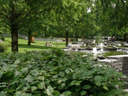 Water feature with fountains, surrounded by shrubs and trees